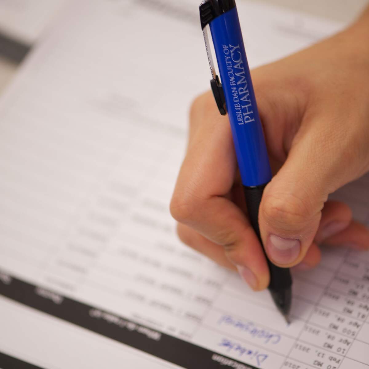 Hand filling out medication form