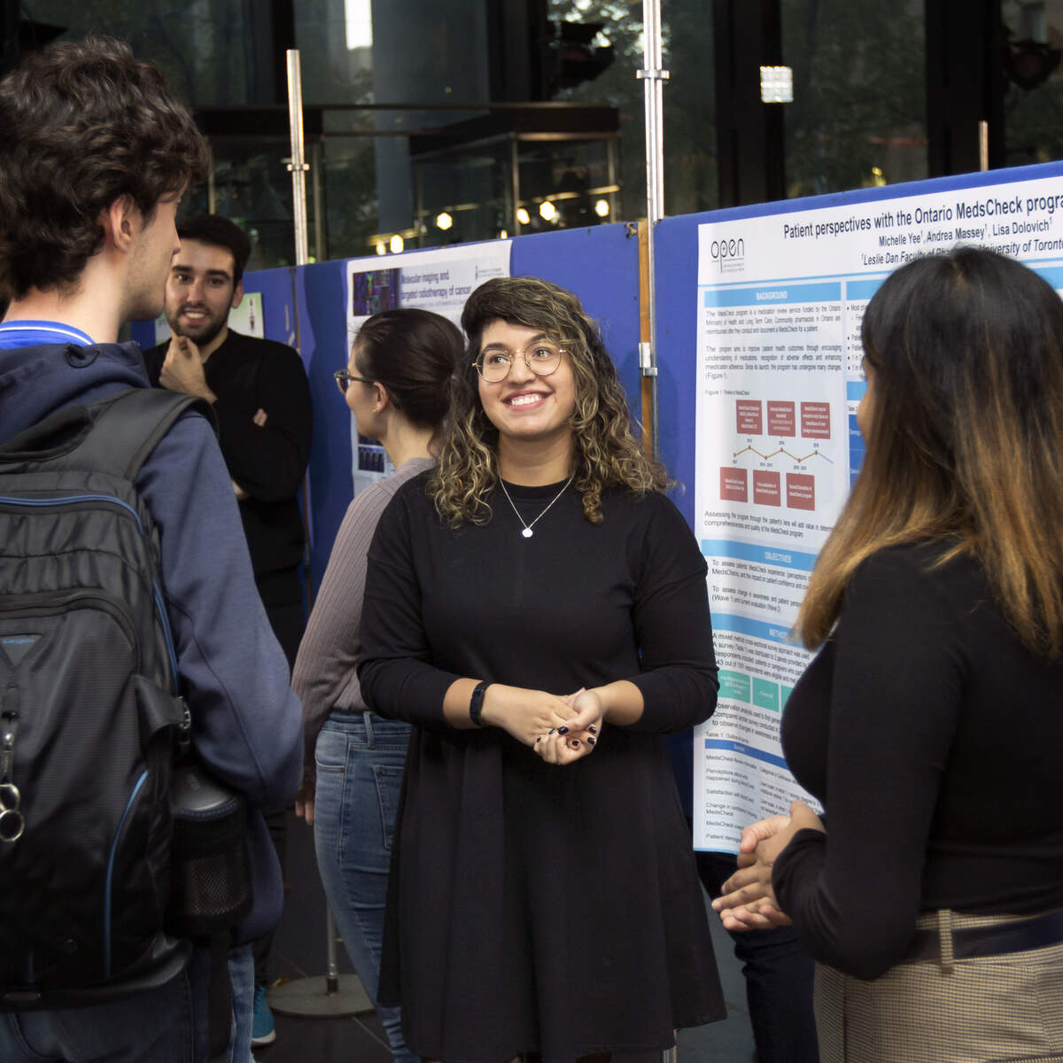 Graduate students talking at poster competition