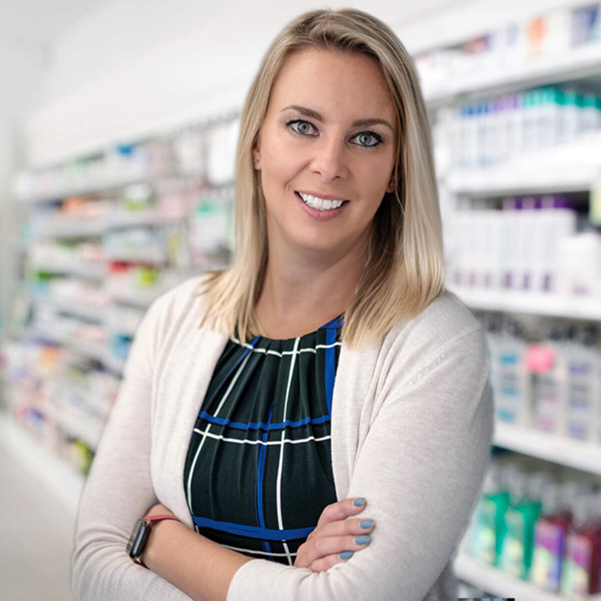 Portrait of Kristen Watt standing in a pharmacy