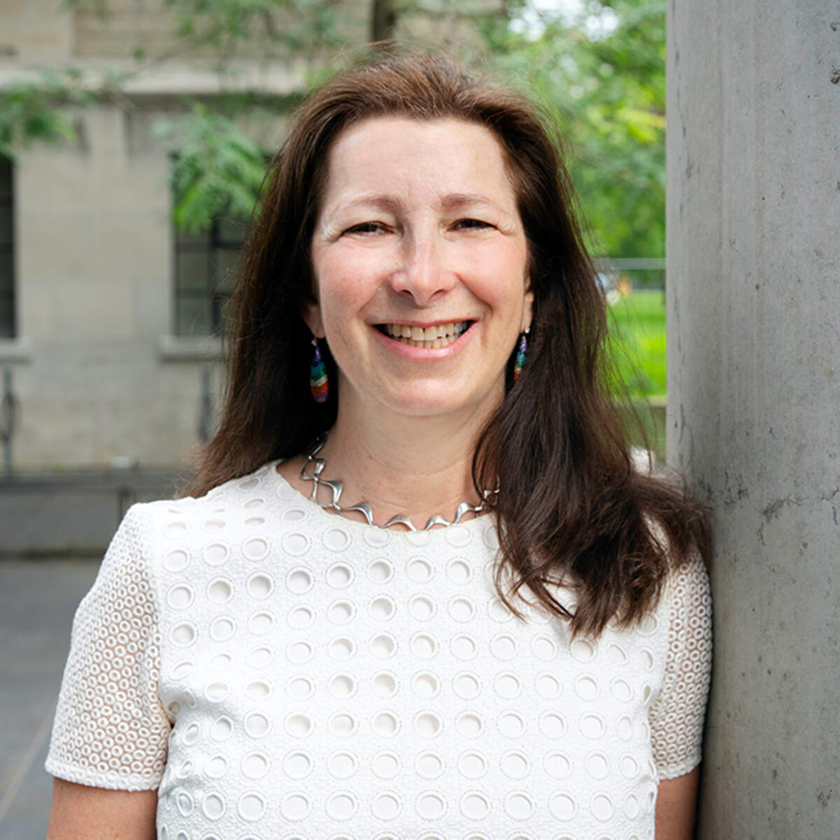 Portrait of University Professor Molly Shoichet outside of Leslie Dan Faculty of Pharmacy Building