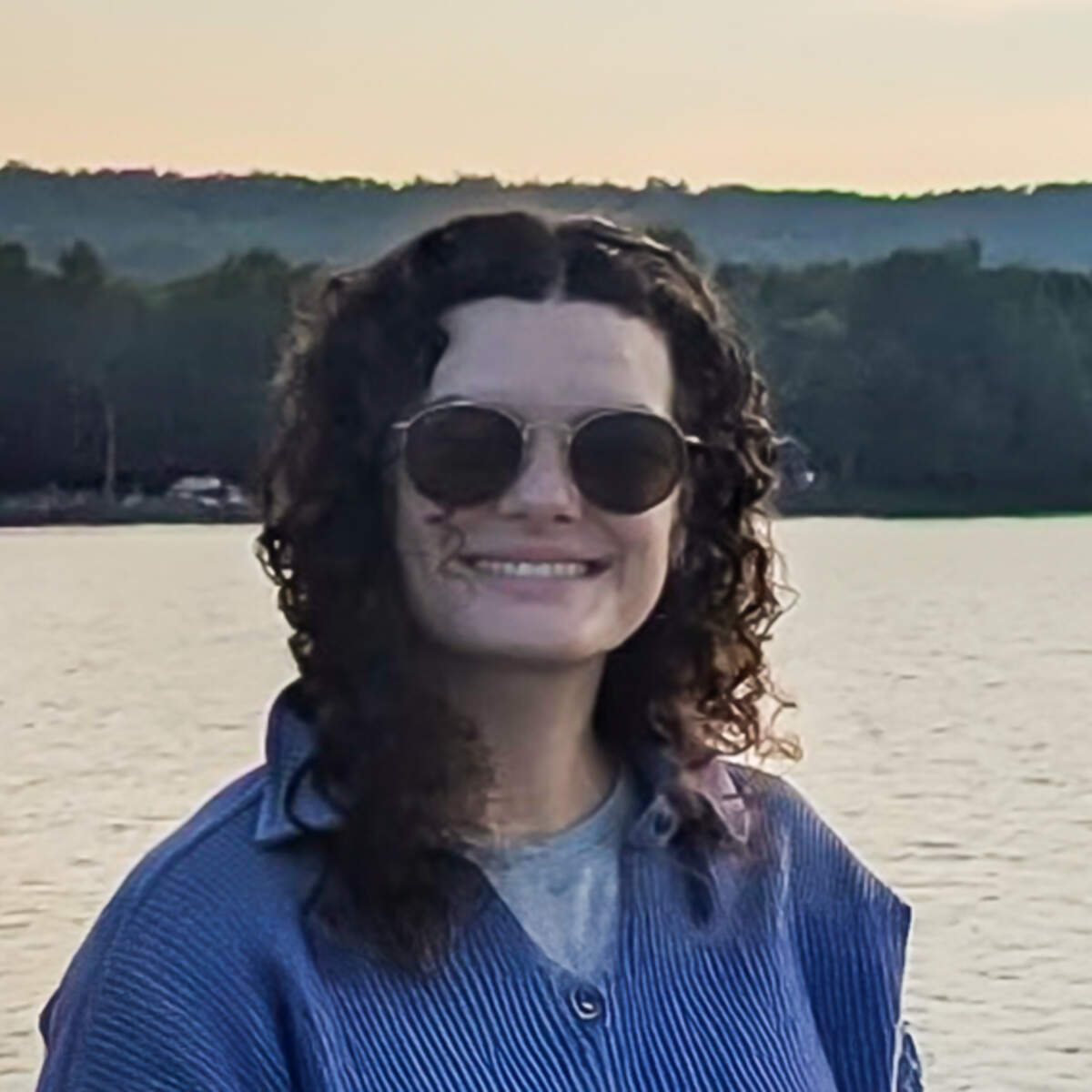 Portrait of PharmD student Alina Montgomery with lake in background at sunset